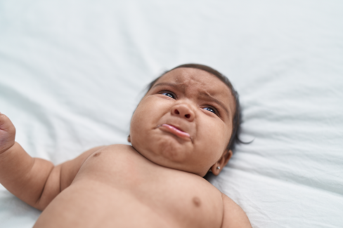 A baby with a sad expression.
