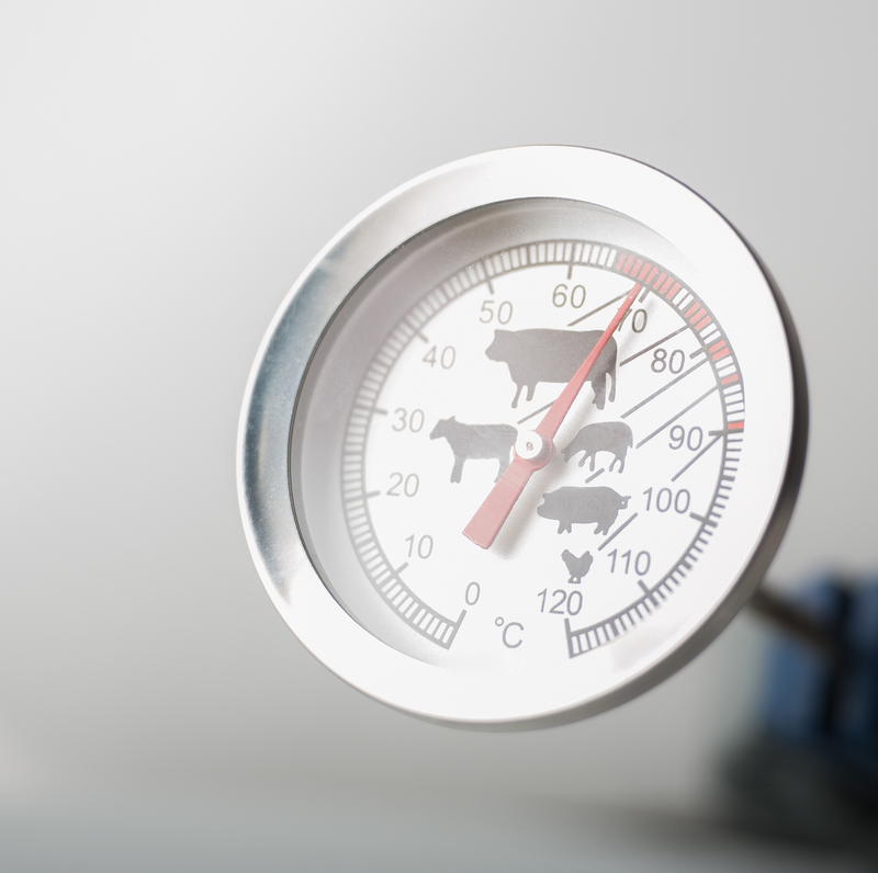 Close up of a meat thermometer showing cooking temperature for beef