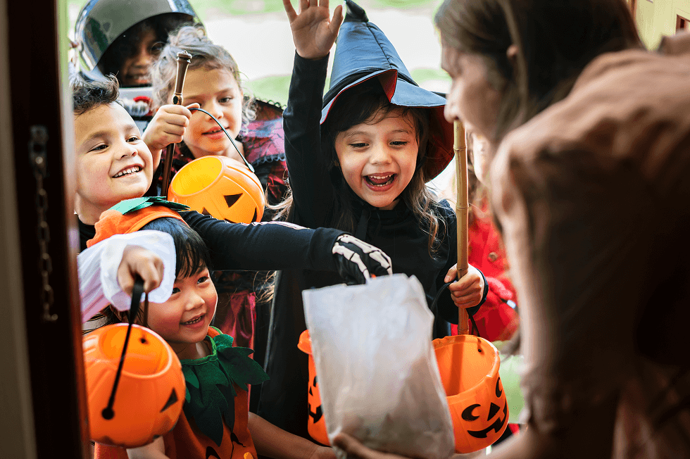 Young kids trick-or-treating on Halloween. 