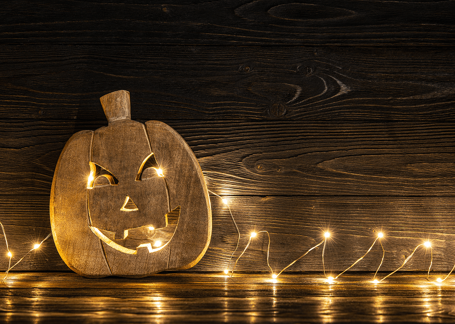 Wooden carved pumpkin lit with LED lights.